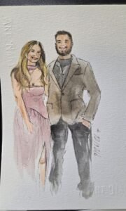 Wedding guests holding personalized watercolor portraits