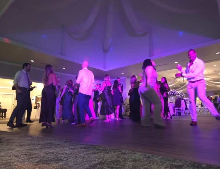 Wedding DJ mixing music during a reception celebration