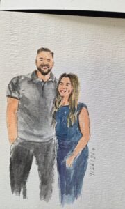 Live wedding guest portrait painting station with watercolor artwork